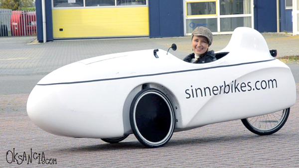 Oksancia cycling in Mango + Sinner Velomobile